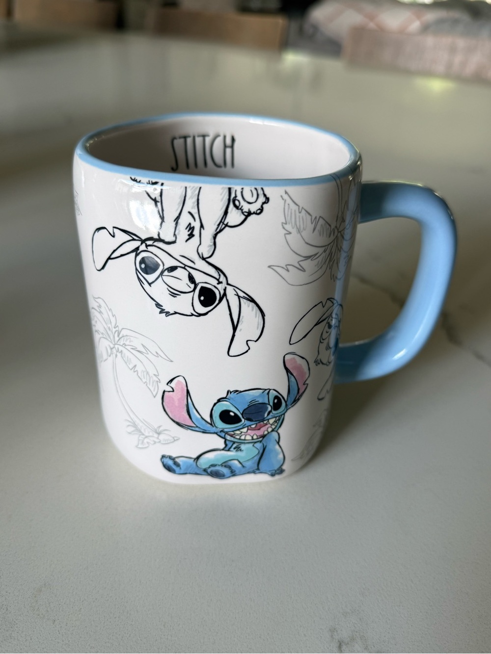 Rae Dunn White Ceramic Stitch Mug with Light Blue Handle and Pink Ear Accents